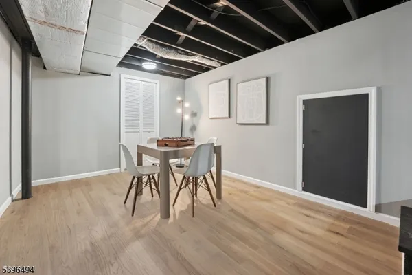 a dining room with furniture and wooden floor