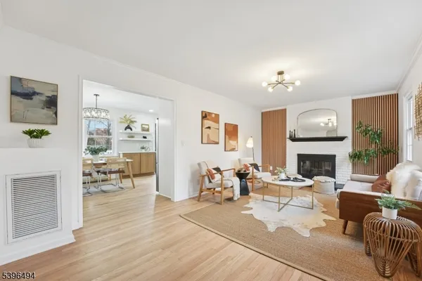 a living room with furniture fireplace and a table