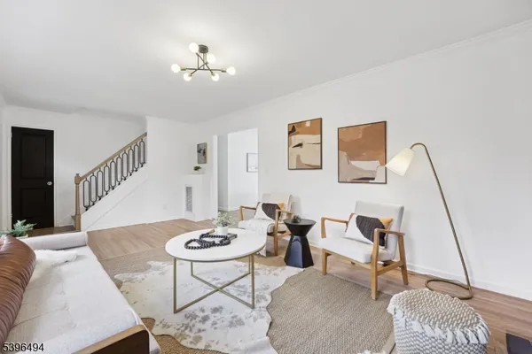 a living room with furniture and a chandelier