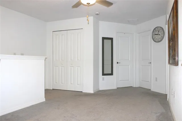 a view of empty room with ceiling fan