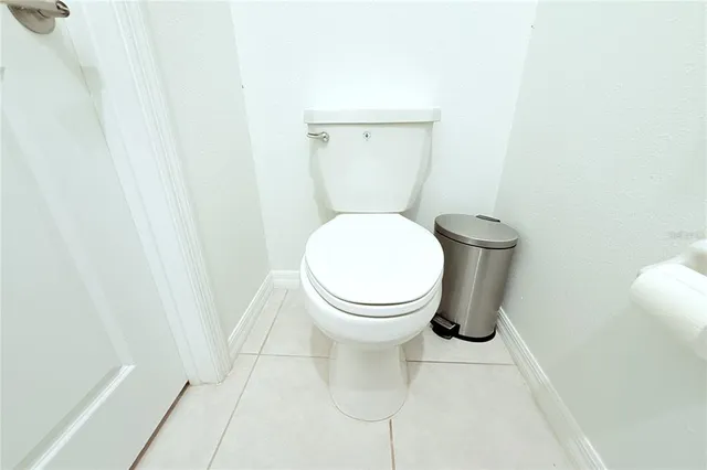 a white toilet sitting next to a white sink
