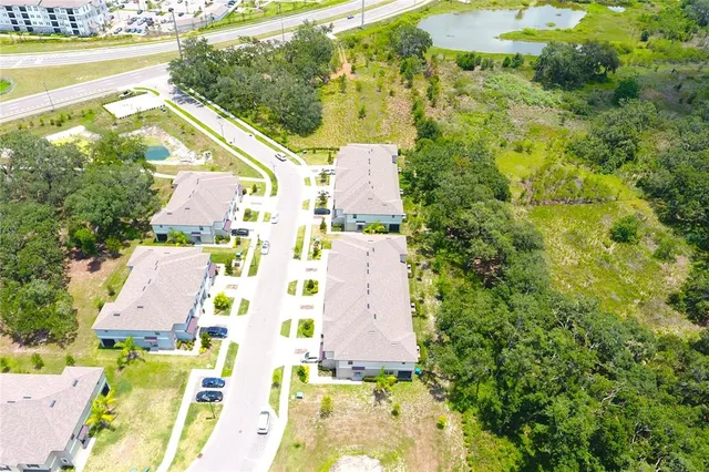 an aerial view of residential house with pool and ocean view
