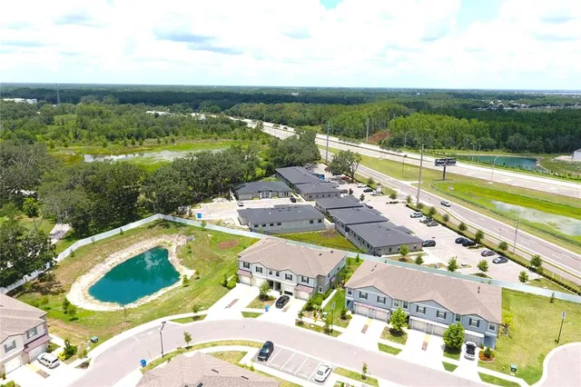 an aerial view of a house with a swimming pool yard and outdoor seating