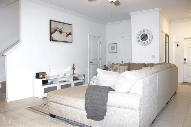 a living room with furniture and wall paintings