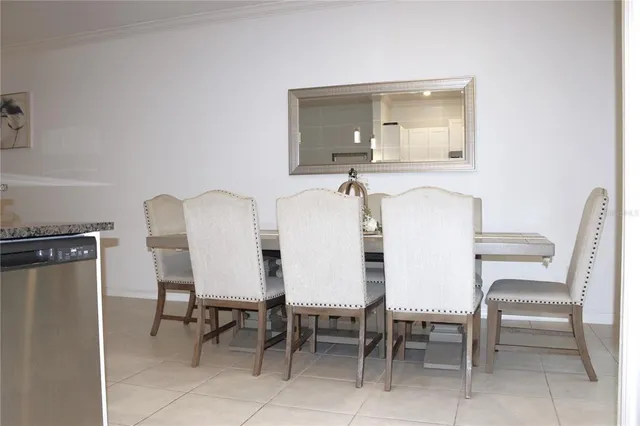 a view of a dining room with furniture and a mirror
