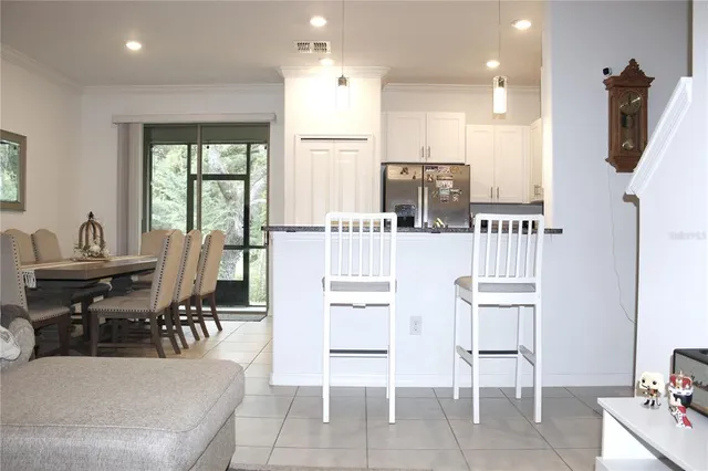 a dining room with furniture and a window