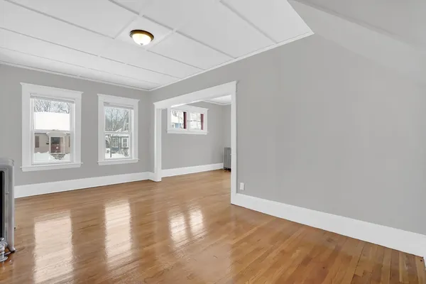 a view of an empty room and wooden floor