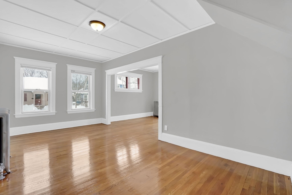 11 Ina Street Springfield, MA 01109 - Photo 14 of 23 a view of an empty room with wooden floor and a window