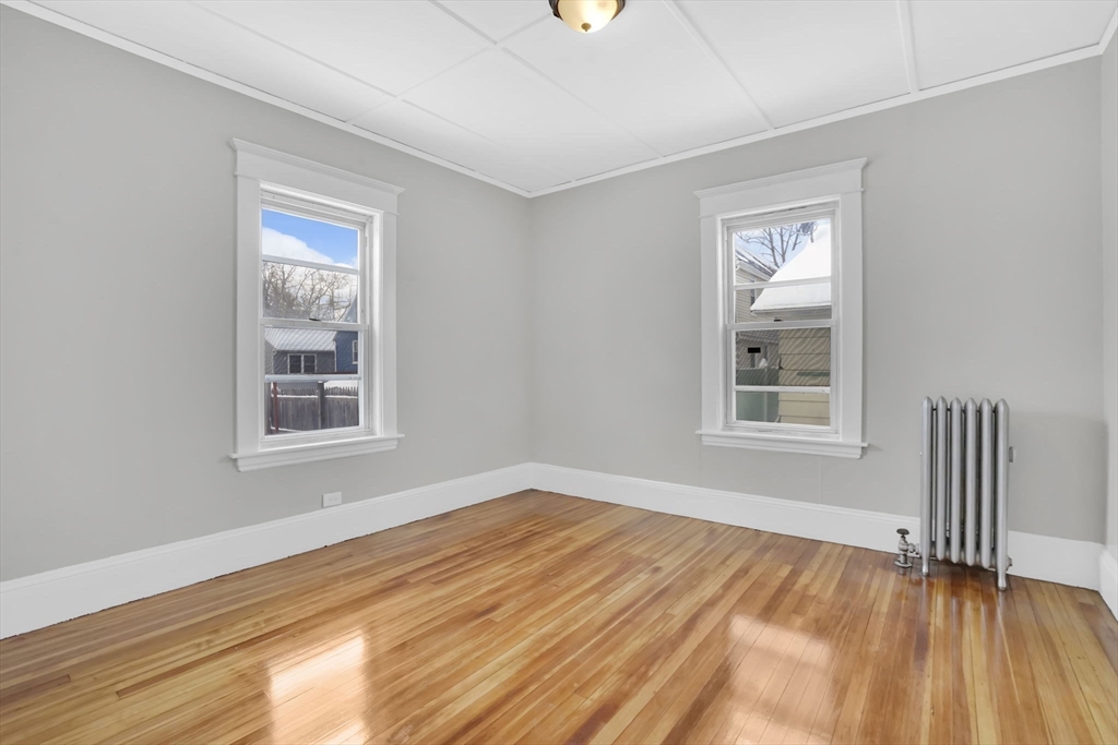 11 Ina Street Springfield, MA 01109 - Photo 17 of 23 a view of an empty room with wooden floor and a window
