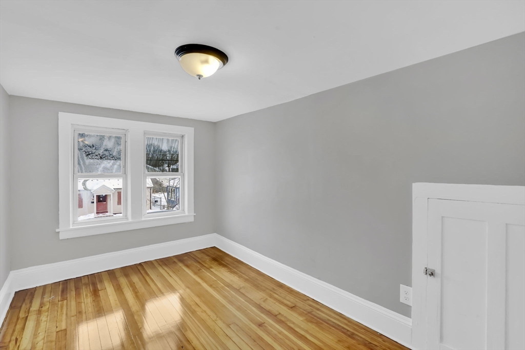 11 Ina Street Springfield, MA 01109 - Photo 20 of 23 a view of empty room with wooden floor and window