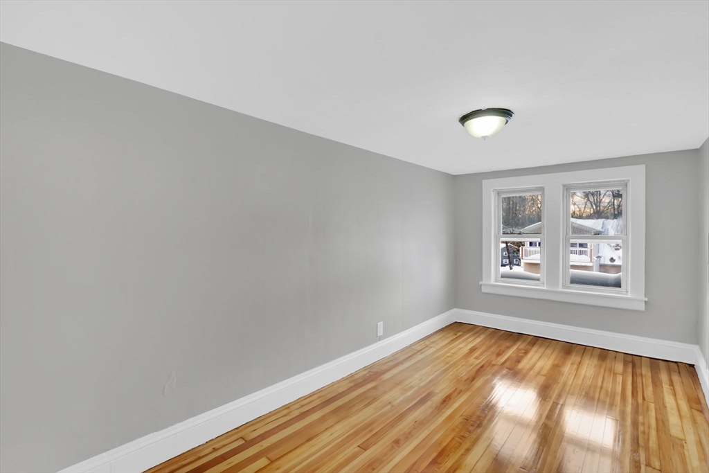 11 Ina Street Springfield, MA 01109 - Photo 23 of 23 an empty room with wooden floor and windows