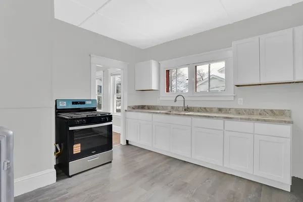 a kitchen with a stove and a refrigerator