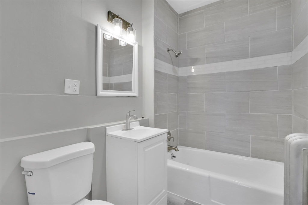 11 Ina Street Springfield, MA 01109 - Photo 7 of 23 a bathroom with a sink a toilet and shower