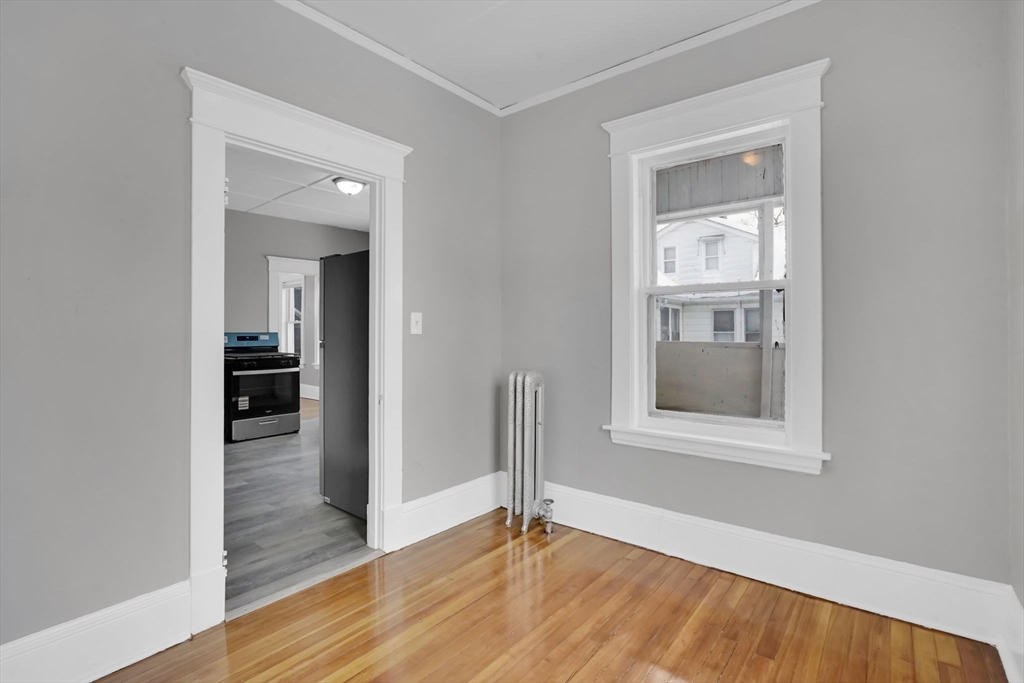 11 Ina Street Springfield, MA 01109 - Photo 8 of 23 an empty room with wooden floor closet and windows