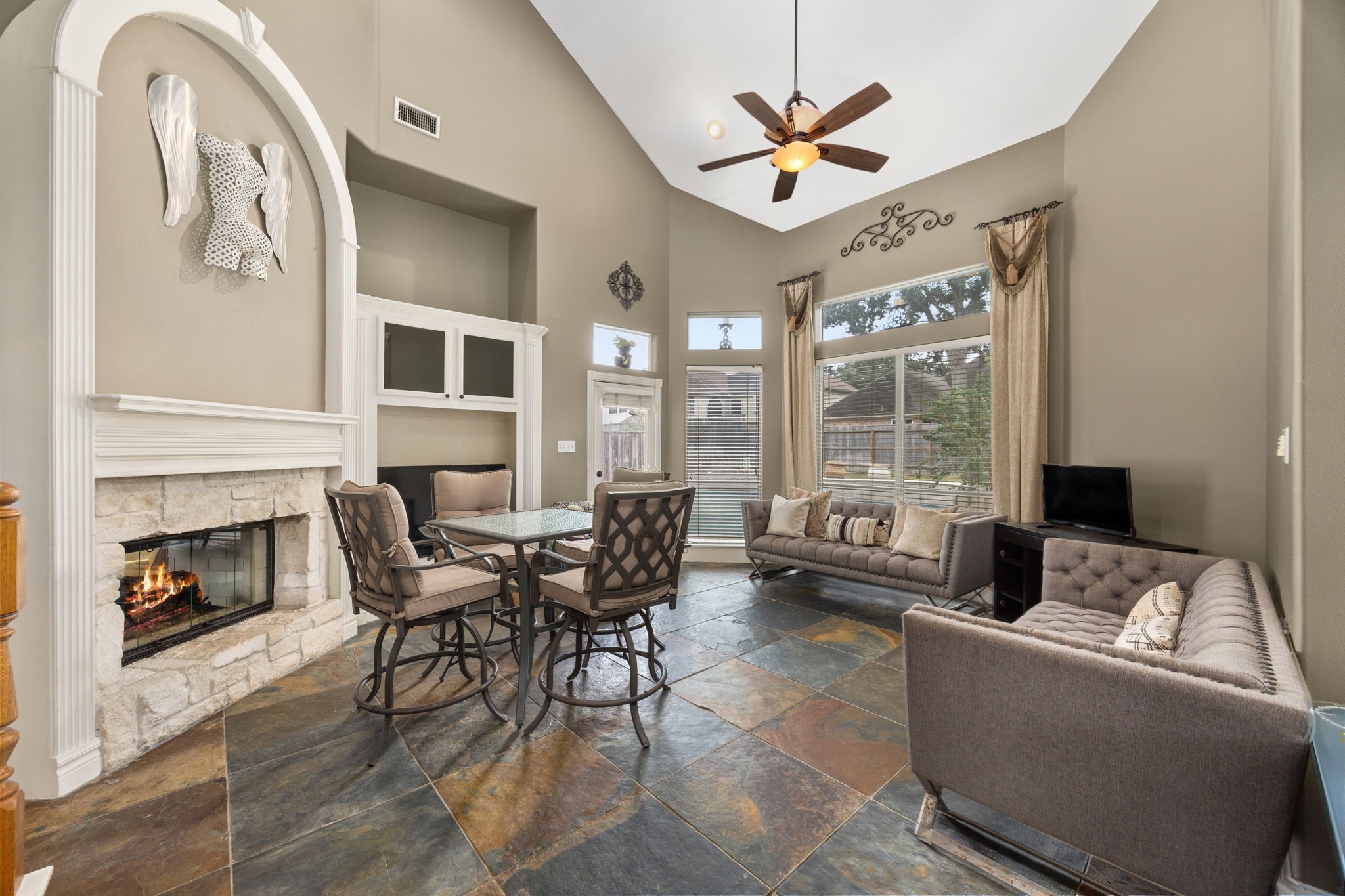 13307 Cypress Pond Road Cypress, TX 77429 - Photo 15 of 50 a living room with furniture a fireplace and a large window