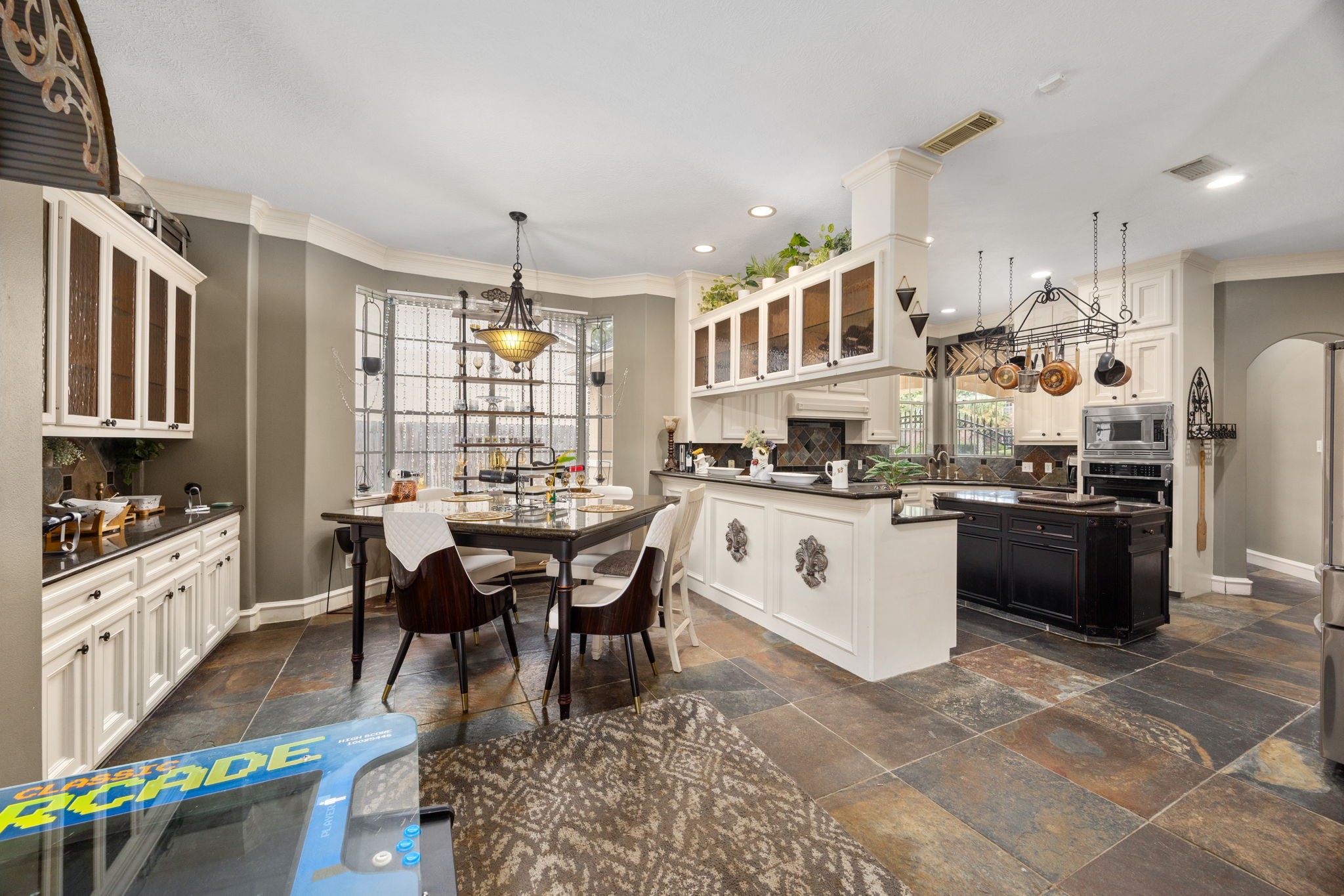 13307 Cypress Pond Road Cypress, TX 77429 - Photo 21 of 50 a kitchen with stainless steel appliances granite countertop a stove a sink dishwasher a dining table and chairs with wooden floor