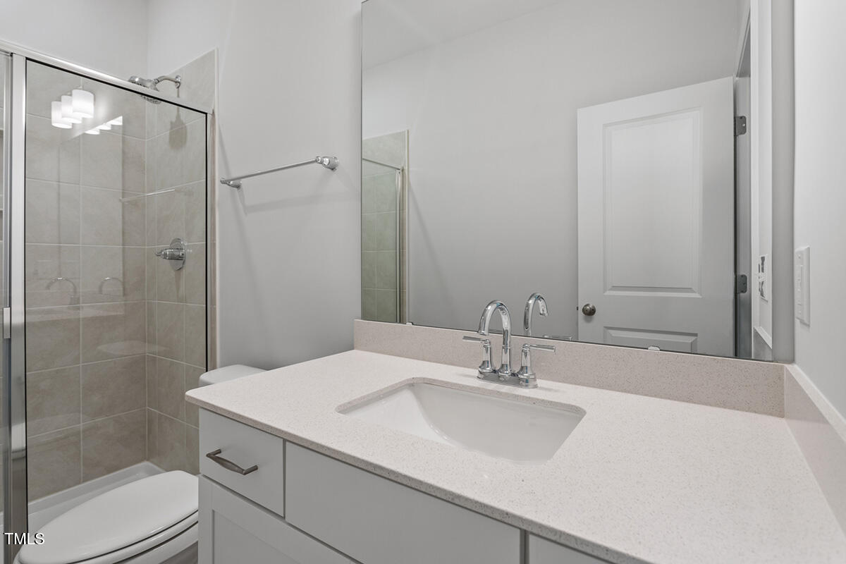 119 Augusta Pond Way, Unit 147 Raleigh, NC 27603 - Photo 12 of 37 a bathroom with a sink and a mirror