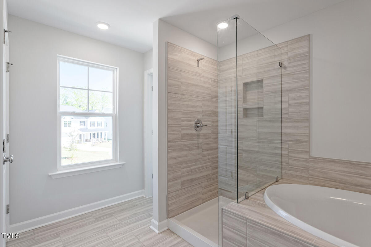 119 Augusta Pond Way, Unit 147 Raleigh, NC 27603 - Photo 16 of 37 a bathroom with a bathtub and shower