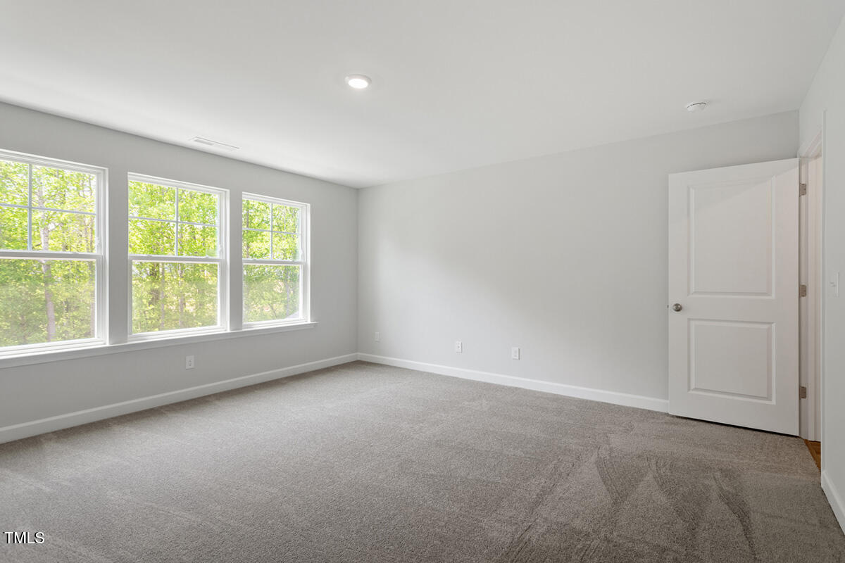 119 Augusta Pond Way, Unit 147 Raleigh, NC 27603 - Photo 18 of 37 an empty room with a window