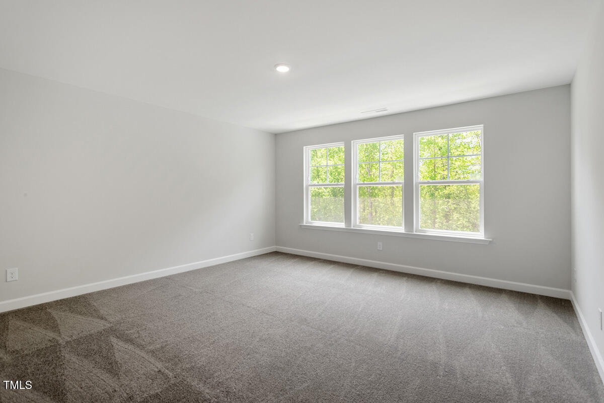 119 Augusta Pond Way, Unit 147 Raleigh, NC 27603 - Photo 19 of 37 an empty room with a window