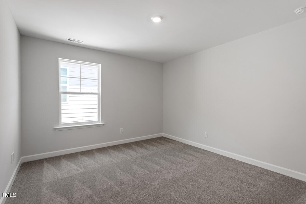 119 Augusta Pond Way, Unit 147 Raleigh, NC 27603 - Photo 21 of 37 an empty room with a window