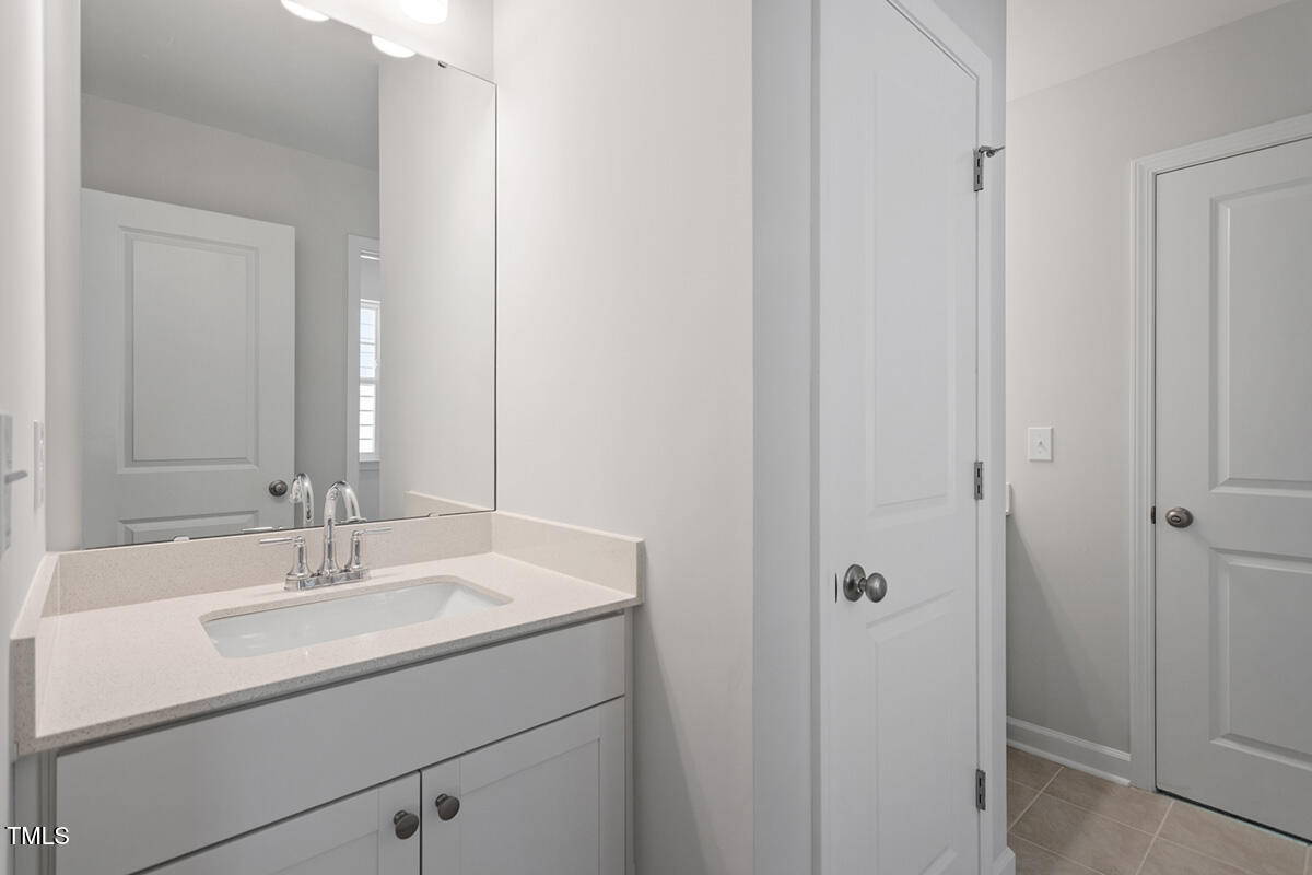 119 Augusta Pond Way, Unit 147 Raleigh, NC 27603 - Photo 22 of 37 a bathroom with a sink and a mirror