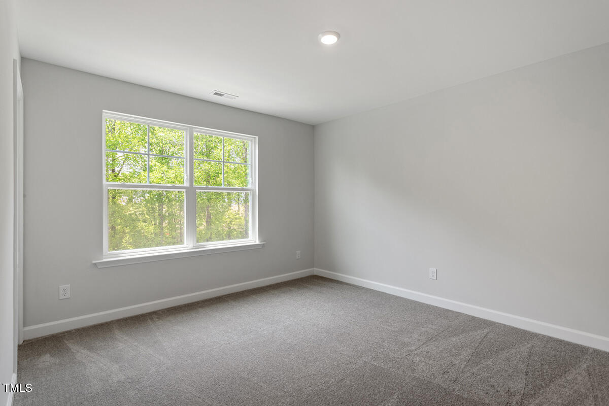 119 Augusta Pond Way, Unit 147 Raleigh, NC 27603 - Photo 24 of 37 an empty room with a window