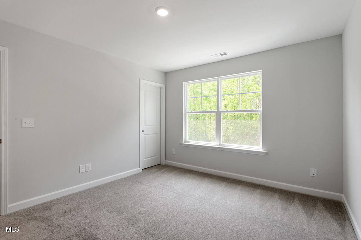 119 Augusta Pond Way, Unit 147 Raleigh, NC 27603 - Photo 25 of 37 an empty room with a window