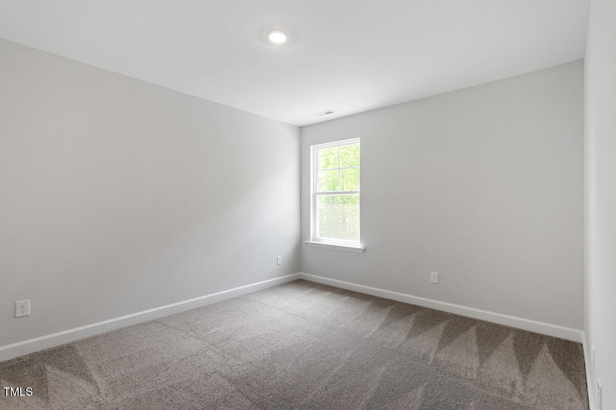 119 Augusta Pond Way, Unit 147 Raleigh, NC 27603 - Photo 26 of 37 an empty room with a window