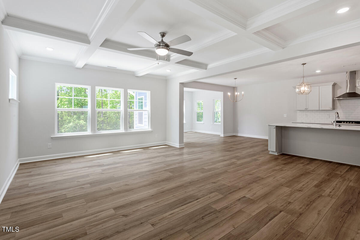 119 Augusta Pond Way, Unit 147 Raleigh, NC 27603 - Photo 10 of 37 a view of an empty room with wooden floor and a window
