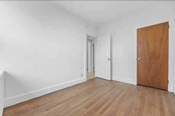 an empty room with wooden floor