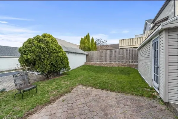 a view of a backyard with plants and a garden