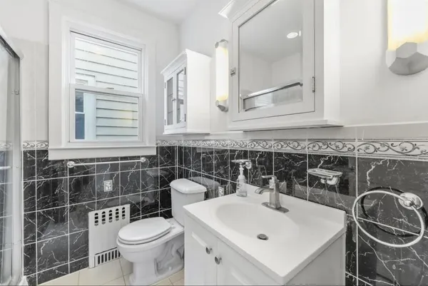 a bathroom with a sink a toilet and a mirror