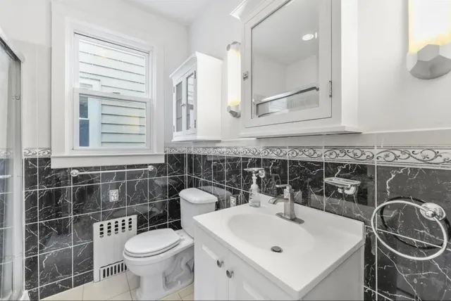 a bathroom with a sink a toilet and a mirror