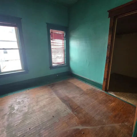 a view of an empty room and a window