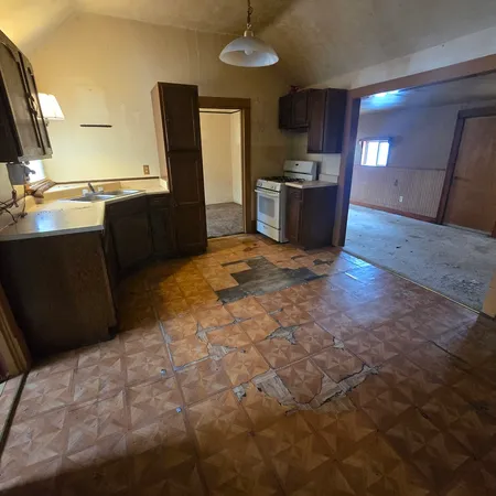 a view of a kitchen with a sink and a refrigerator