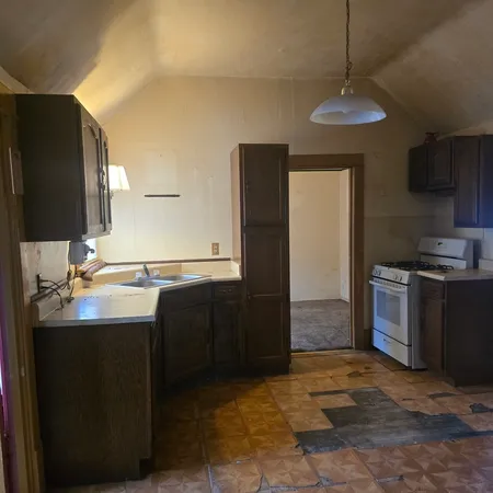 a kitchen with stainless steel appliances a sink stove and refrigerator