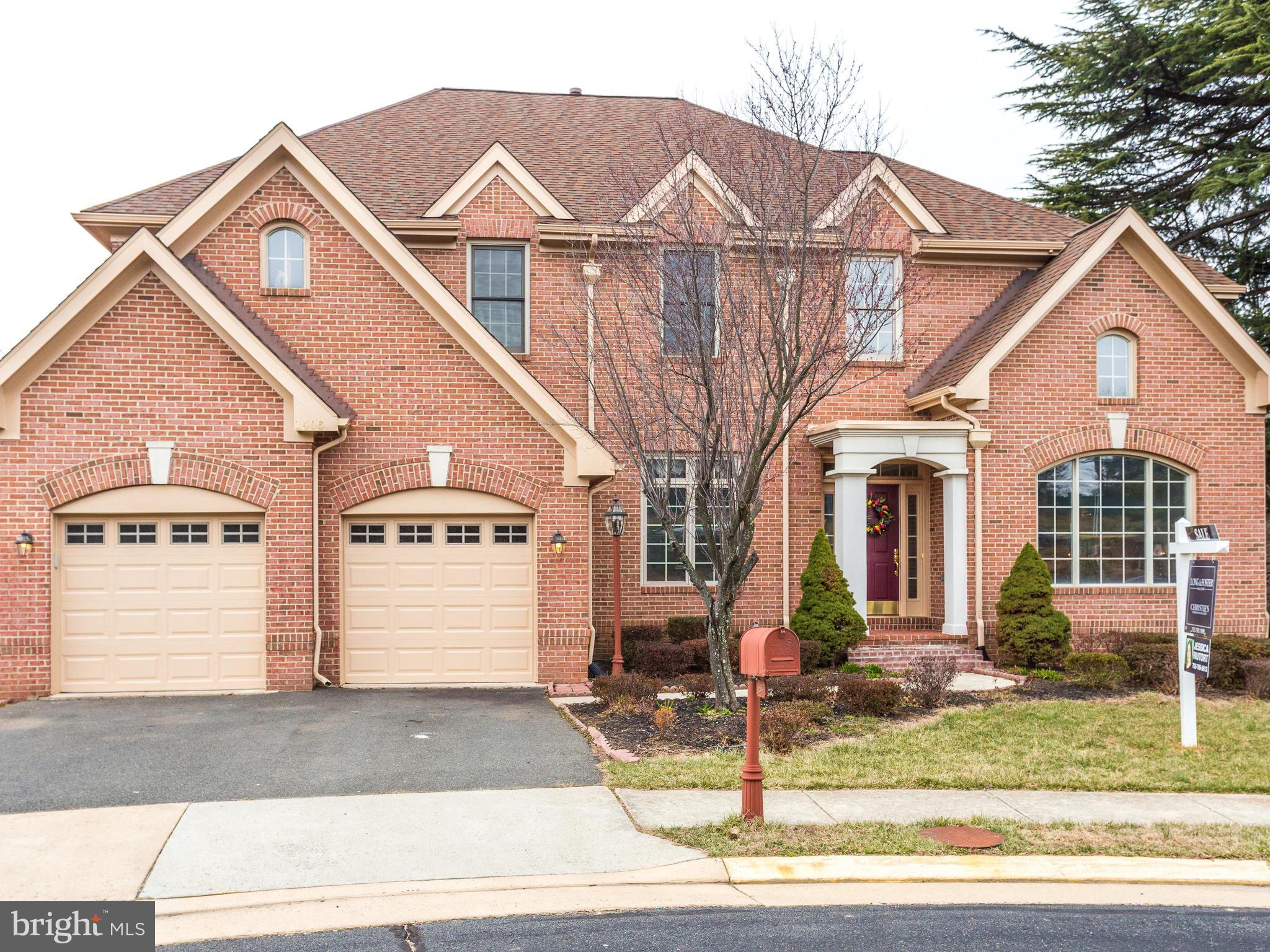 1406 Stanbridge Place Vienna, VA 22182 - Photo 1 of 30 a view of a white house with large windows next to a road