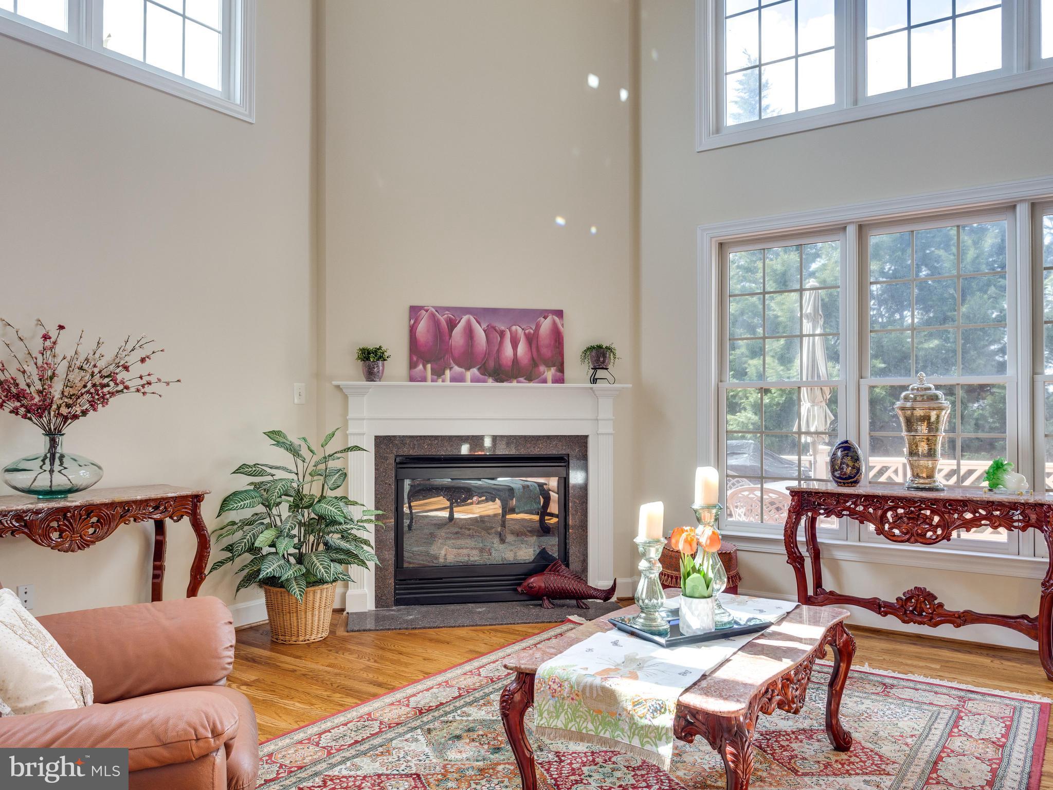 1406 Stanbridge Place Vienna, VA 22182 - Photo 13 of 30 a living room with furniture a large window and a fireplace
