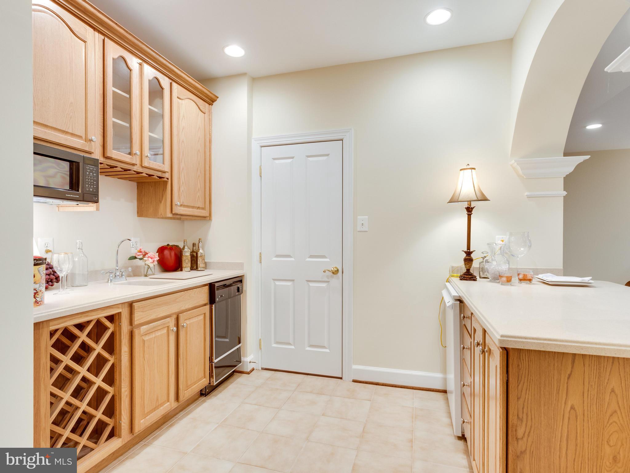 1406 Stanbridge Place Vienna, VA 22182 - Photo 26 of 30 a kitchen with a sink stove and cabinets