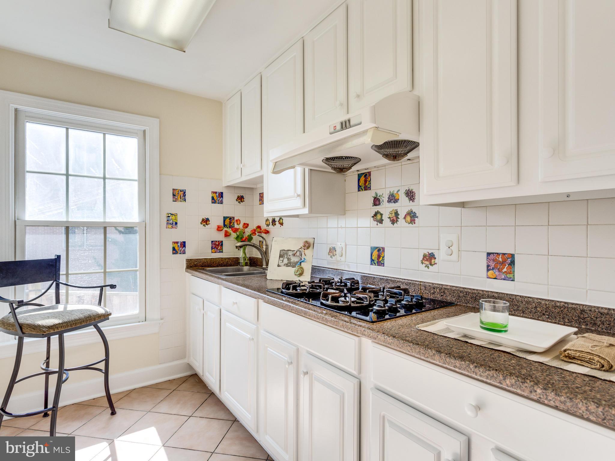 1406 Stanbridge Place Vienna, VA 22182 - Photo 29 of 30 a kitchen with stainless steel appliances granite countertop a stove a sink and a white cabinets
