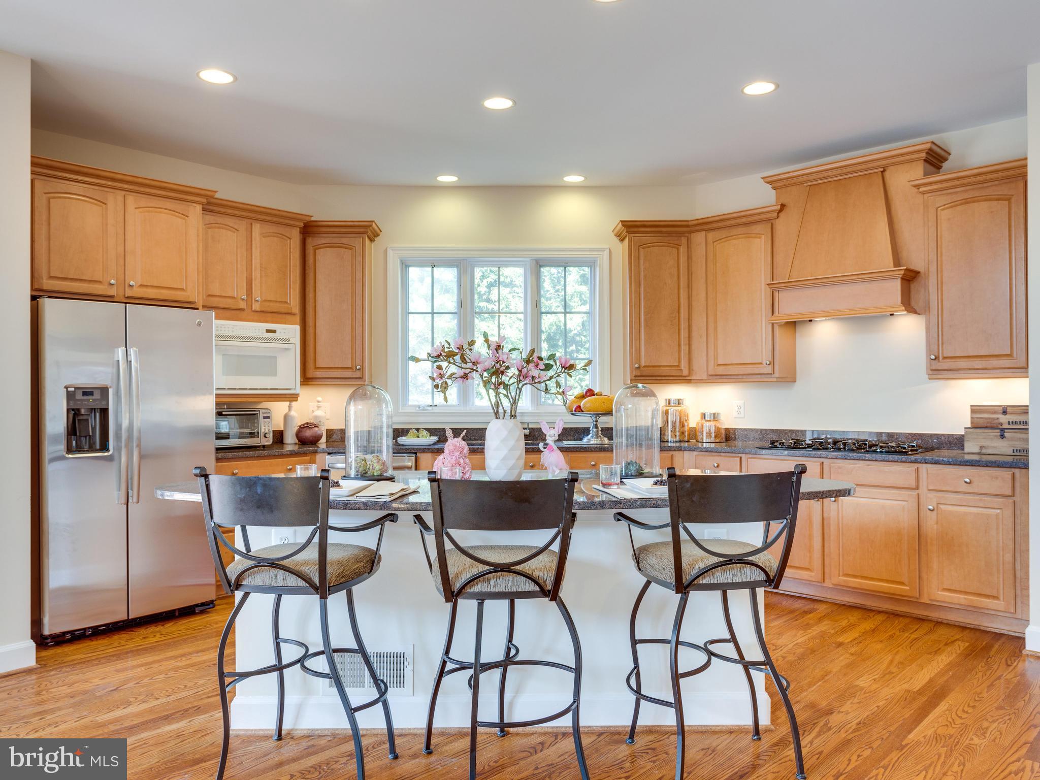 1406 Stanbridge Place Vienna, VA 22182 - Photo 9 of 30 a kitchen with stainless steel appliances granite countertop counter top space cabinets and wooden floor