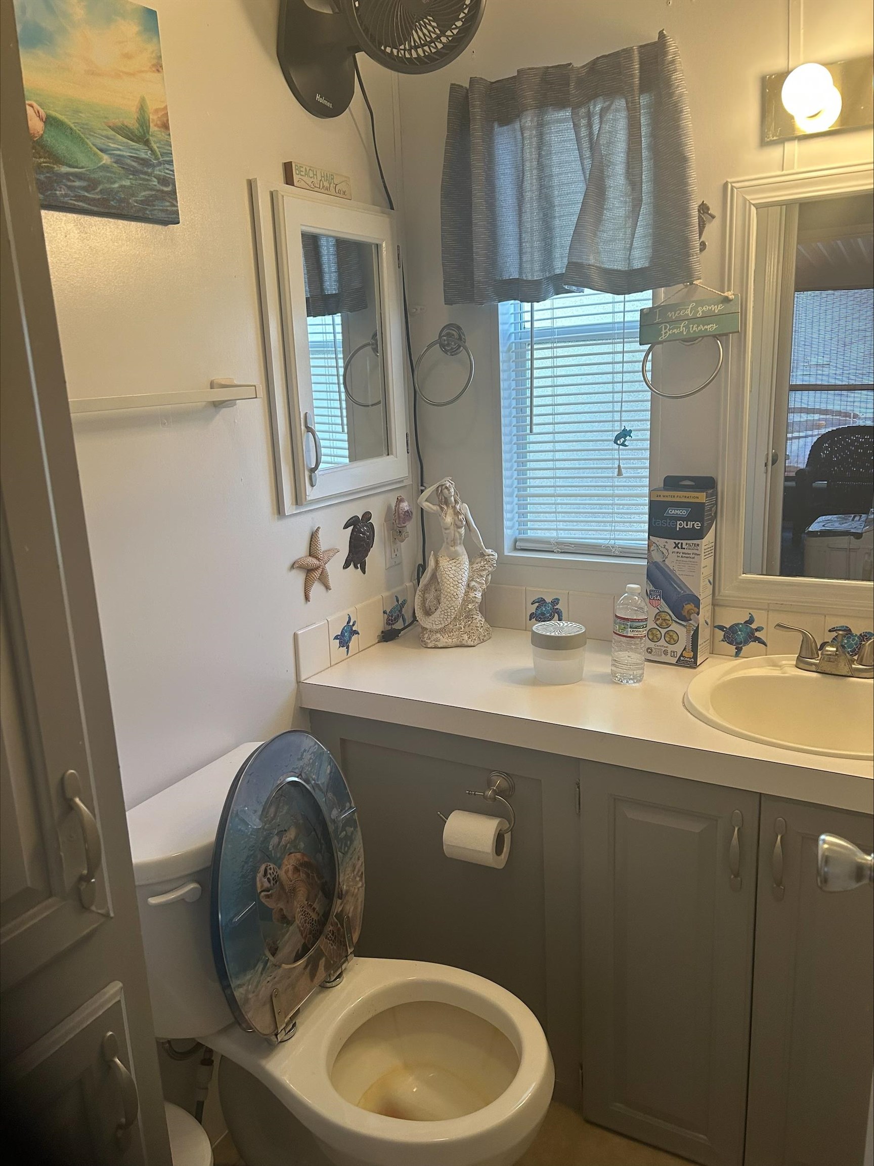 709 Us Rt 9 S, Unit 636 Cape May, NJ 08204 - Photo 8 of 12 a bathroom with a granite countertop toilet sink and mirror