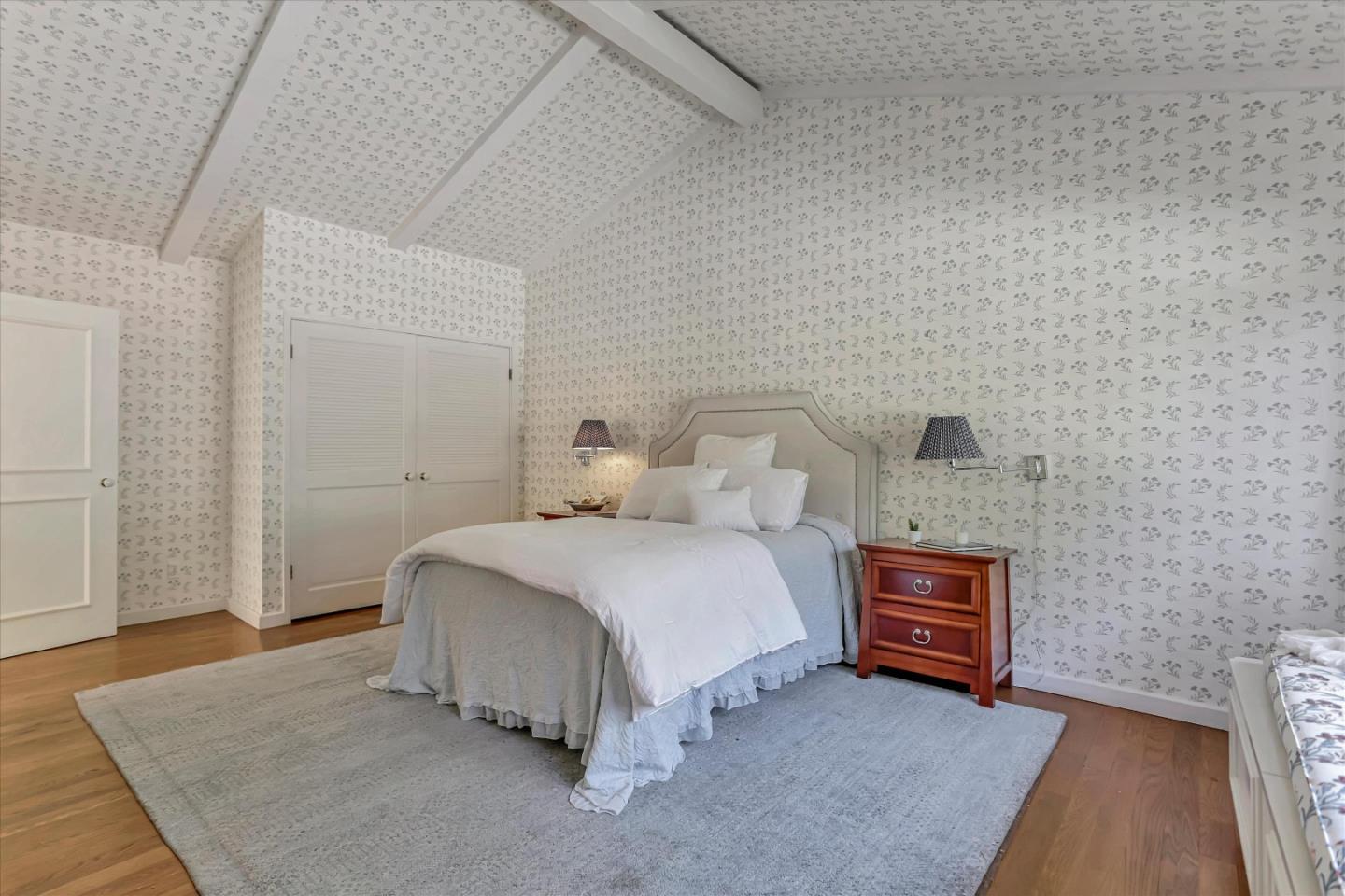 22 La Rancheria Carmel Valley, CA 93924 - Photo 28 of 44 a spacious bedroom with a bed and a couch
