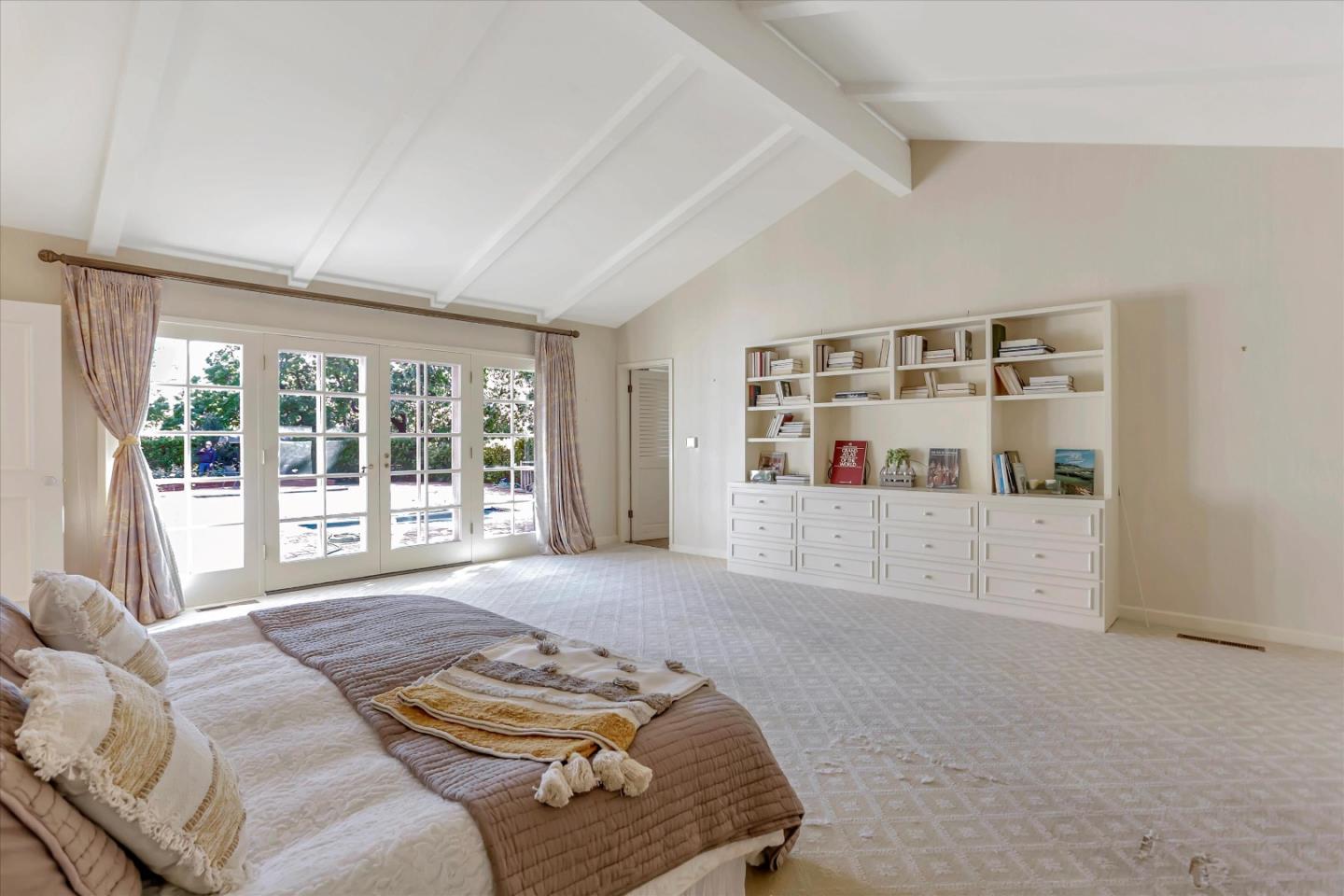 22 La Rancheria Carmel Valley, CA 93924 - Photo 31 of 44 a bedroom with furniture and a large window