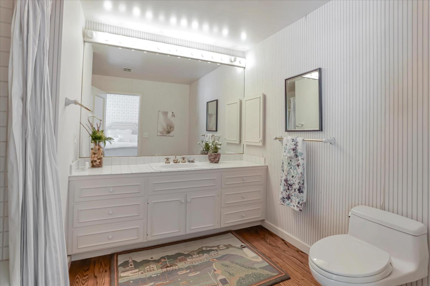22 La Rancheria Carmel Valley, CA 93924 - Photo 32 of 44 a spacious bathroom with a toilet a sink a mirror a bathtub and shower