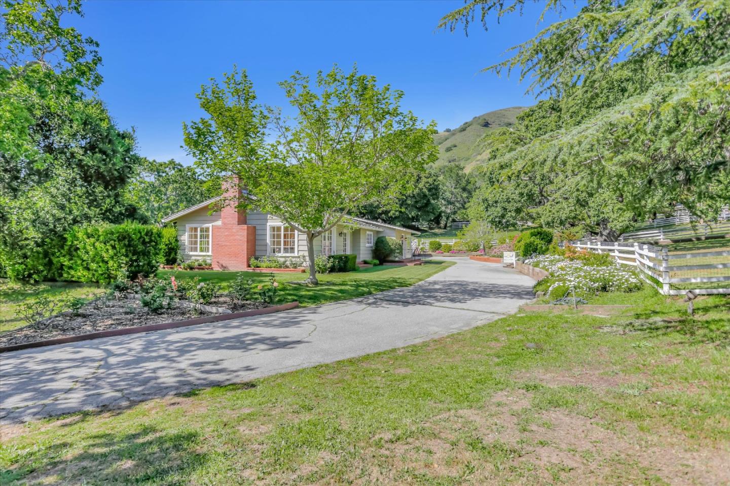 22 La Rancheria Carmel Valley, CA 93924 - Photo 4 of 44 a front view of a house with a yard and mountain view