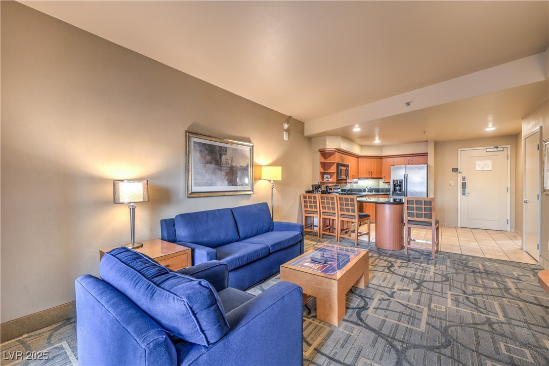 211 East Flamingo Road, Unit 1503 Las Vegas, NV 89169 - Photo 14 of 44 Carpeted living area with recessed lighting and tile patterned flooring