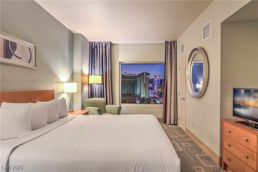 211 East Flamingo Road, Unit 1503 Las Vegas, NV 89169 - Photo 17 of 44 Bedroom featuring dark colored carpet