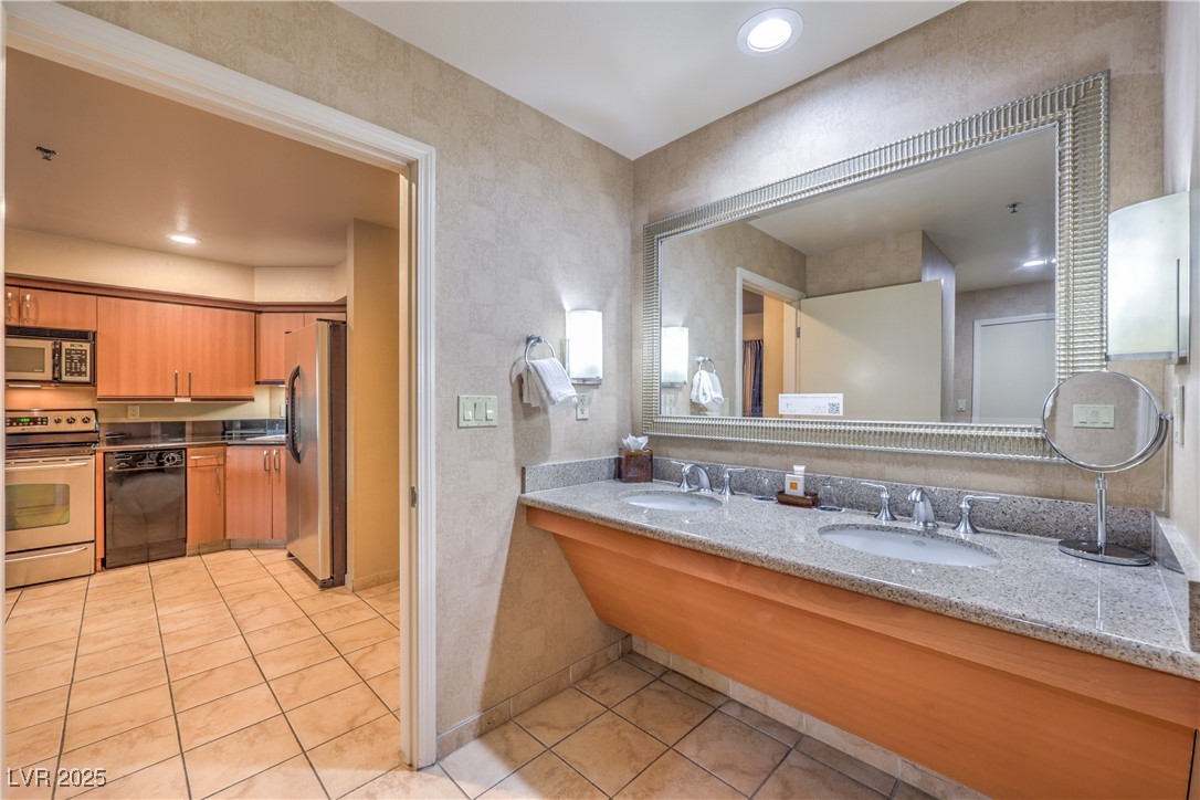 211 East Flamingo Road, Unit 1503 Las Vegas, NV 89169 - Photo 25 of 44 Full bath with double vanity, light tile patterned flooring, and recessed lighting